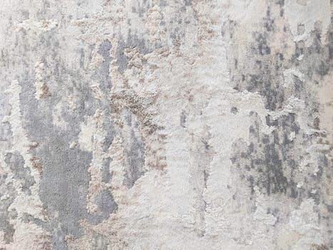 The texture of a short-haired spotted carpet in gray and black tones.Texture or background