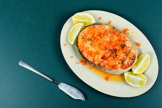 Grilled salmon or trout steak with orange and lime sauce. Space for text.