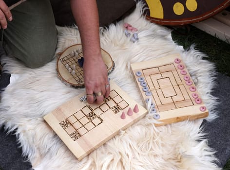 Cracow, Poland - April 11, 2023: Ancient board games in knight camp at the festival of historical reconstruction