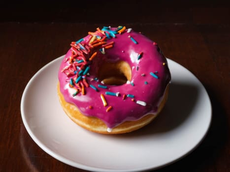 Chocolate donuts on the table. Colorful with sweets and candies