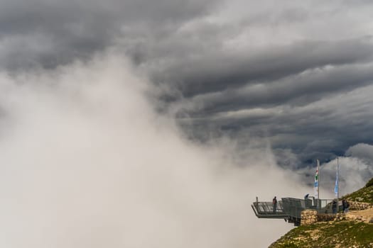 Dachstein, Austria - June 25th, 2020: the 5fingers plattform with a 400m drop offers an adrenaline rush at one of the most spectacular views in the Alps - also on misty days.