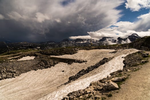 A spectacular view with sun and dark clouds at the Krippenstein in the Dachstein Mountains
