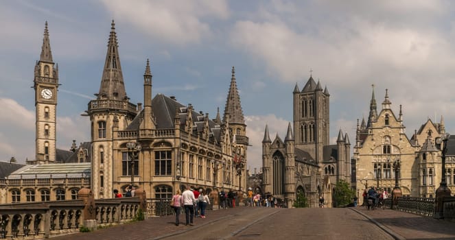 Ghent, Belgium - June 10th, 2019: A view over a lively bridge to the center of the famous historic old town of Ghent in Belgium