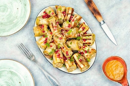 Delicious Badrijani, vegan vegetarian healthy food. Eggplant rolls on the table. Top view.