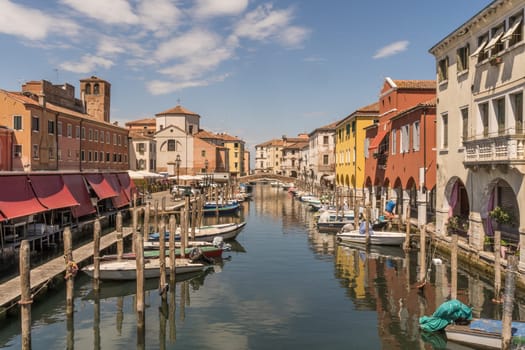 Chioggia, Italy - July 10th, 2022: View over the old town along one of the canal of the pleasant medieval city of Chioggia.