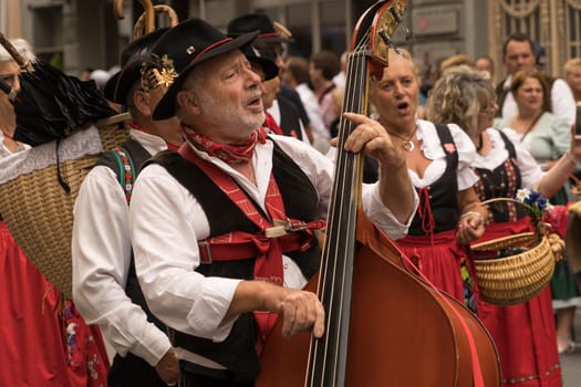 Villach, Austria - August 6, 2022: Musicians enjoy the procession of 'Villacher Kirchtag', the largest traditional folk festival in Austria, after some years of cancellation due to Covid.