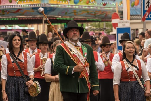Villach, Austria - August 6, 2022: People enjoy the procession of 'Villacher Kirchtag', the largest traditional folk festival in Austria, after some years of cancellation due to Covid.