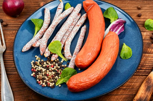 Smoked kabanos sausages, prepared from mixed minced meat with the addition of spices and garlic. Salami sticks and sausages.