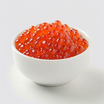 Fresh red salmon caviar in a white bowl.