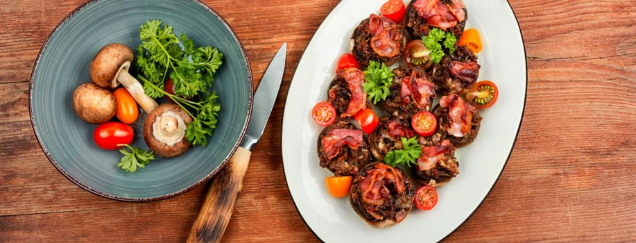 Homemade champignon mushrooms stuffed with minced meat and bacon. Copy space.