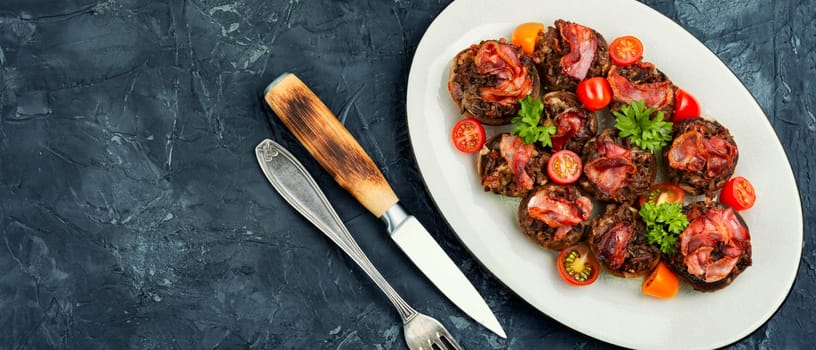 Homemade champignon mushrooms stuffed with minced meat and bacon. Copy space.