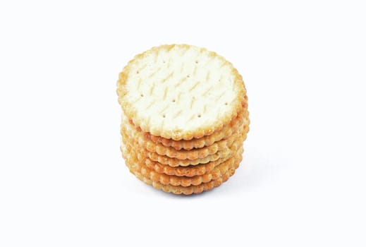 Salty crackers stacked on white background