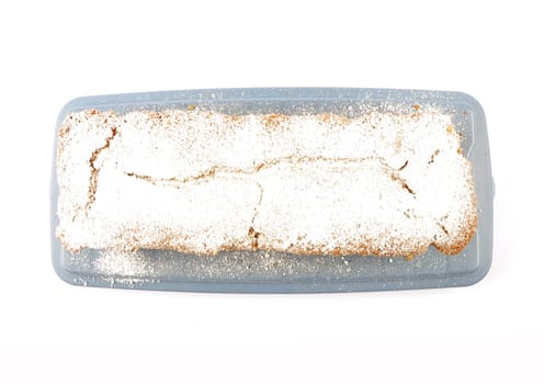 Freshly baked sand cake on cake plate and white background