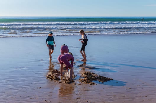 Caparica, Portugal: January 21, 2024: Kids playing at the beach in Costa da Caparica, near Lisbon. Portugal