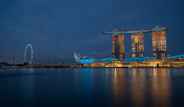 Marina Bay, Singapore - 4, June, 2023 - The view of Art Science Museum and Sands Hotel illuminated at night