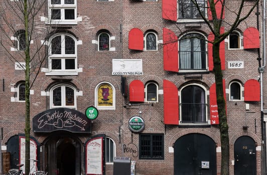 Amsterdam, Netherlands - April 21, 2023: De Wallen - called the red light district. It is famous for its entertainment character: brothers, coffee shops, pubs and restaurants located along the canals