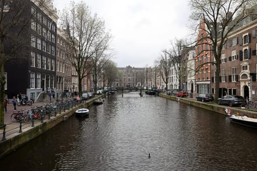 Amsterdam, Netherlands - April 21, 2023: De Wallen - called the red light district. It is famous for its entertainment character: brothers, coffee shops, pubs and restaurants located along the canals