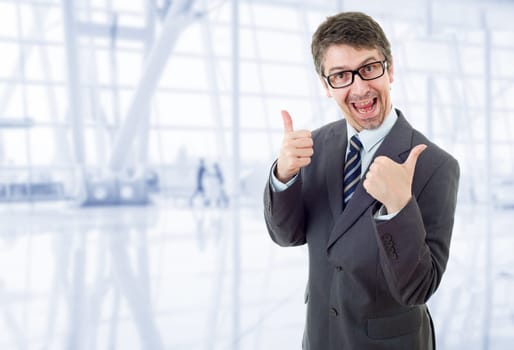 young business man going thumbs up, at the office