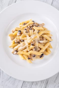 Portion of creamy garlic penne pasta with mushroom