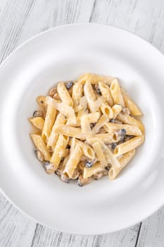 Portion of creamy garlic penne pasta with mushroom