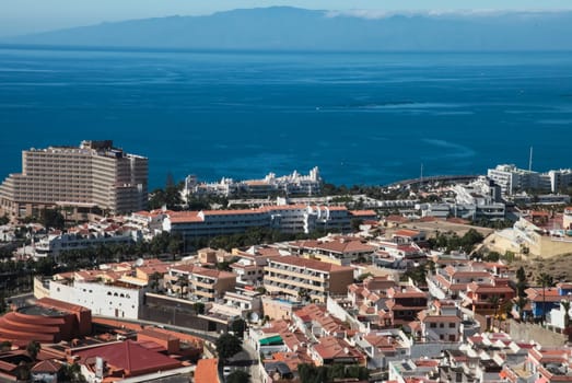 Costa Adeje, Tenerife, Spain - July 28, 2013: The islands of Tenerife is a resort for tourists. Coast of the sea and hotels on the beach.