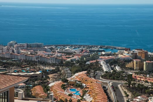 Costa Adeje, Tenerife, Spain - July 28, 2013: The islands of Tenerife is a resort for tourists. Coast of the sea and hotels on the beach.