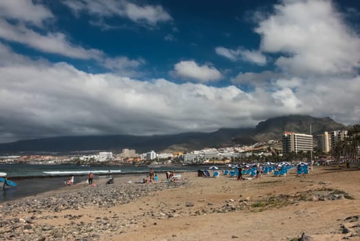 Costa Adeje, Tenerife, Spain - July 28, 2013: The islands of Tenerife is a resort for tourists. Coast of the sea and hotels on the beach.