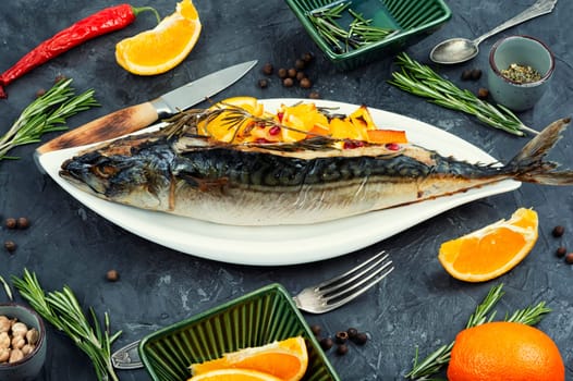 Scomber roast. Mackerel fish grilled baked with oranges sauce and rosemary served on a stylish plate.
