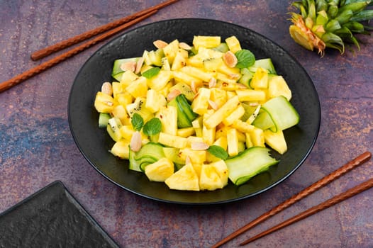 Appetizing salad with pineapple, cucumber and nuts