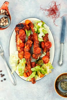 Braised or stewed pork ribs in tomato sauce on old rustic wooden table. Ready for eat.