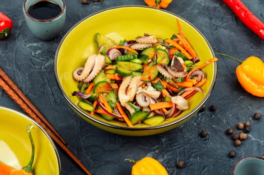Salad of squid, cucumber, onion and octopus. Korean cuisine with seafood