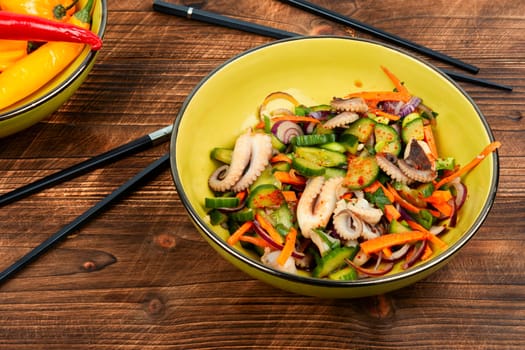 Salad of squid, cucumber, onion and octopus. Korean cuisine with seafood