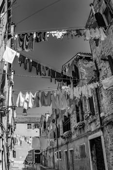clothes on a clothesline in a narrow street in Venice, Italy