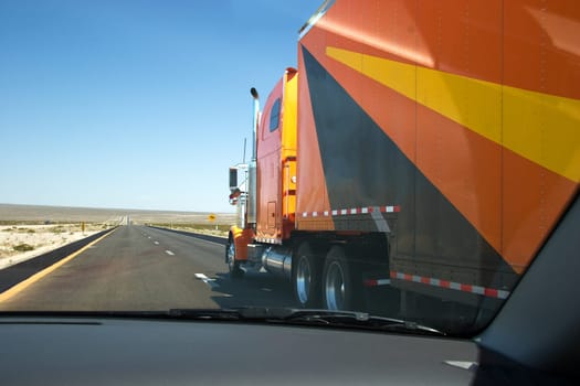 overtaking a huge lorry at the highway in desert area, USA