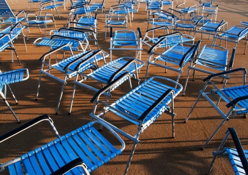 benches with plastic seat covers in blue at the deck of the ship in harmonic order