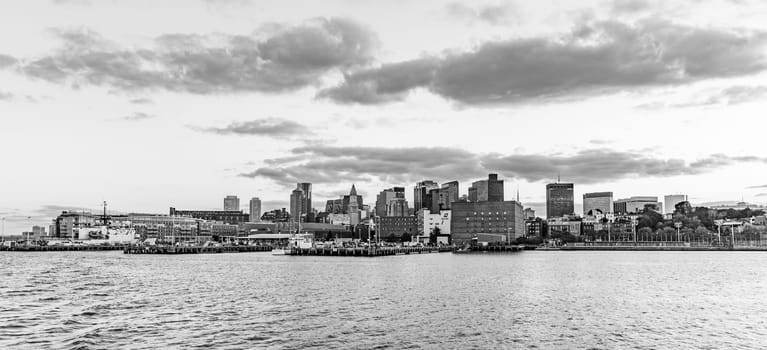 view to skyline of Boston in sunset with pier