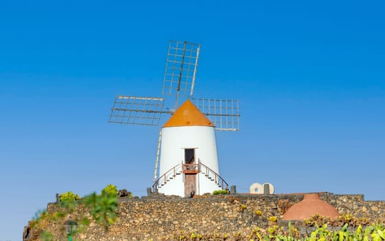 Windmill in tropical cactus garden in Guatiza village, popular attraction in Lanzarote, Canary islands
