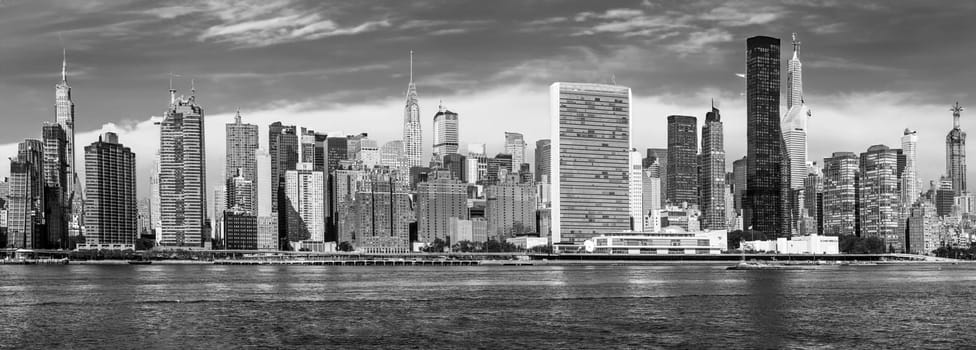 skyline of New York seen from east river. The East River is a salt water tidal strait in New York City. The waterway connects Upper New York Bay to Long Island Sound.