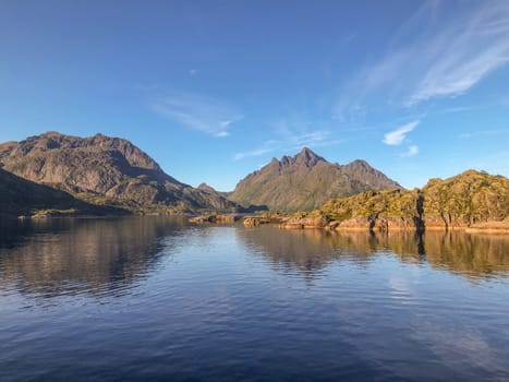 scenic view to the entrance of the Trollfjord with reflection in the ocean in Norway