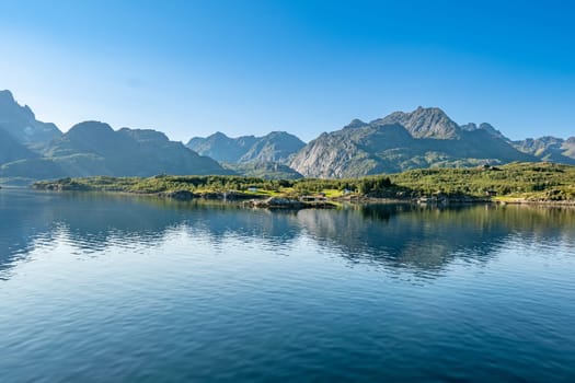 scenic view to the entrance of the Trollfjord with reflection in the ocean in Norway