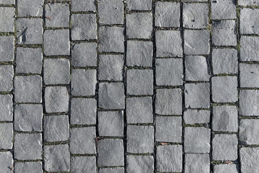 detail of grey cobblestone pattern at the sidewalk as harmonic background