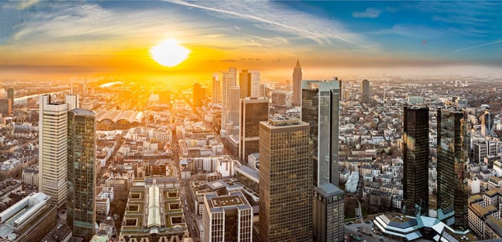 scenic aerial view to skyline of Frankfurt with skyscraper in dawn and spectacular sunset