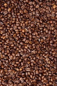 Scattered roasted coffee beans, full frame