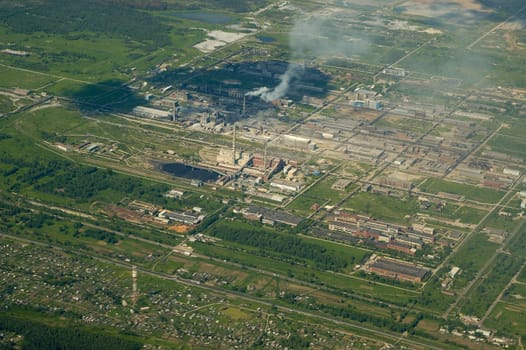 Top view of the industrial center of the city, factories and smoke pipes.