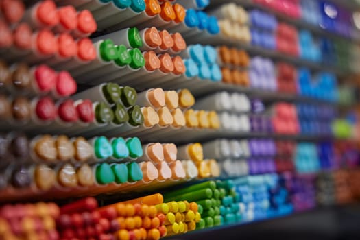 Colorful markers of assorted colors on stationery rack shelves. Various equipment office or school supplies for drawing, writing or painting