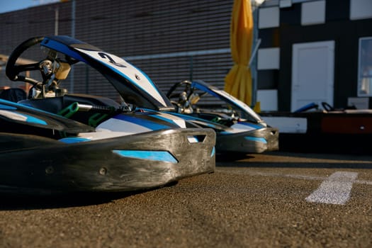 Go-cart sports car packed on outdoor track ready for recreational pursuit. Professional motor race vehicles