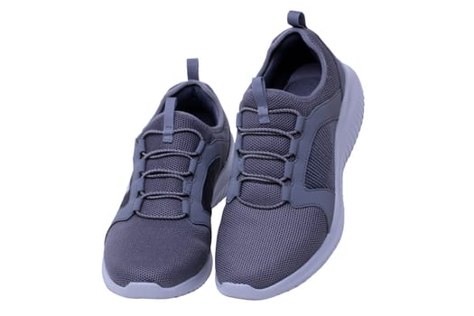 Closeup of a pair of modern silver gray sneakers or sports shoes isolated on a white background. Clipping path. Elegant and trendy mans shoes. Macro.
