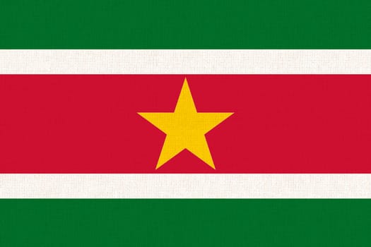 Flag of Suriname. Surinamese flag on fabric surface. Fabric texture. National symbol. Republic of Suriname. Surinamese national flag