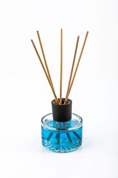 Scent sticks in the glass on the white background.