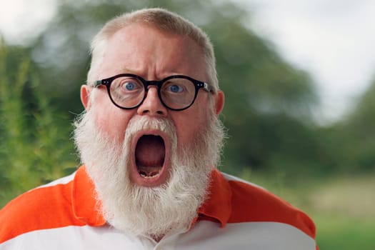 Portrait from emotional screaming senior man with beard